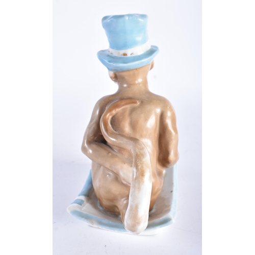 665 - A RARE 19TH CENTURY CONTINENTAL PORCELAIN CHAMBERSTICK modelled as a seated monkey wearing a top hat... 