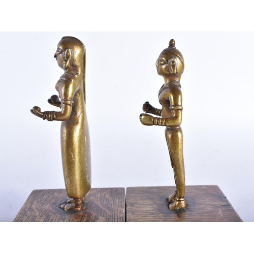 666 - A PAIR OF 19TH CENTURY INDIAN HINDU BRONZE DEITIES upon wooden bases. 16 cm high.