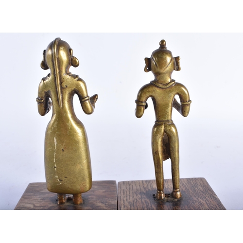 666 - A PAIR OF 19TH CENTURY INDIAN HINDU BRONZE DEITIES upon wooden bases. 16 cm high.