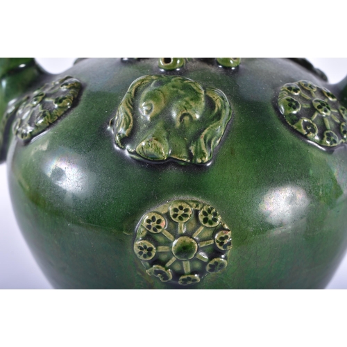 696 - AN UNUSUAL ANTIQUE GREEN GLAZED TWIN HANDLED POTTERY PUZZLE JUG. 22 cm high.