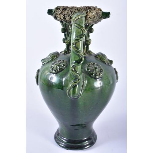 696 - AN UNUSUAL ANTIQUE GREEN GLAZED TWIN HANDLED POTTERY PUZZLE JUG. 22 cm high.