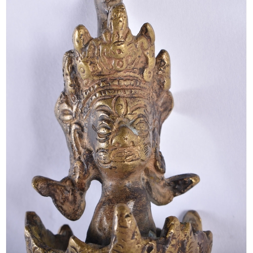 721 - A LARGE LATE 19TH CENTURY TIBETAN BRONZE BUDDHISTIC PHURBA decorated with mask heads. 48 cm long.