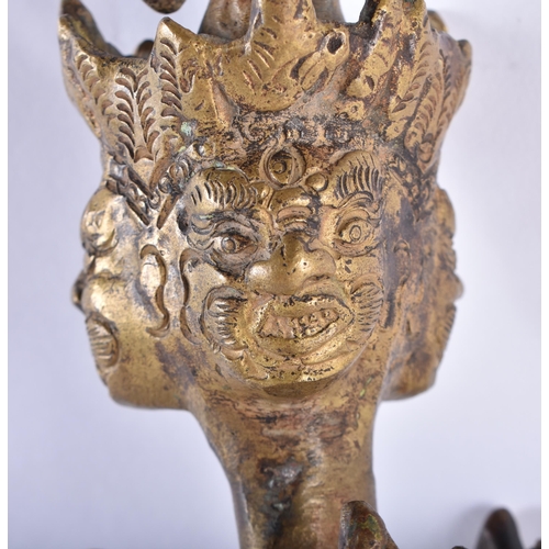 721 - A LARGE LATE 19TH CENTURY TIBETAN BRONZE BUDDHISTIC PHURBA decorated with mask heads. 48 cm long.