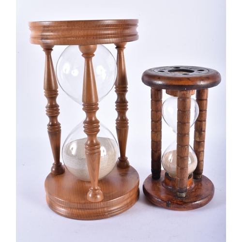 750 - TWO VINTAGE ENGLISH CARVED WOOD SAND TIMERS. Largest 24.5 cm high. (2)