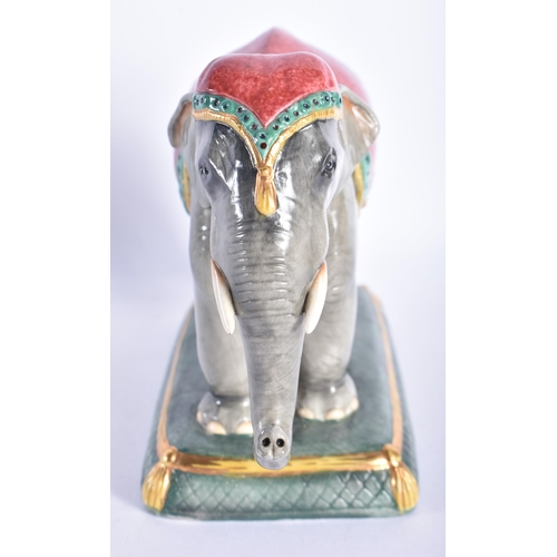 868 - A HALCYON DAYS PORCELAIN FIGURE OF AN ELEPHANT. 14 cm wide.