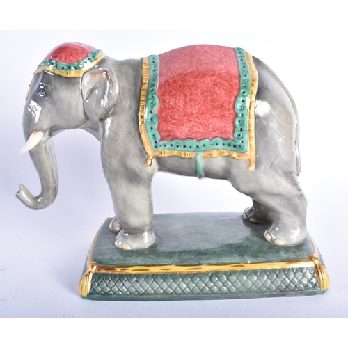 868 - A HALCYON DAYS PORCELAIN FIGURE OF AN ELEPHANT. 14 cm wide.