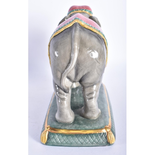 868 - A HALCYON DAYS PORCELAIN FIGURE OF AN ELEPHANT. 14 cm wide.