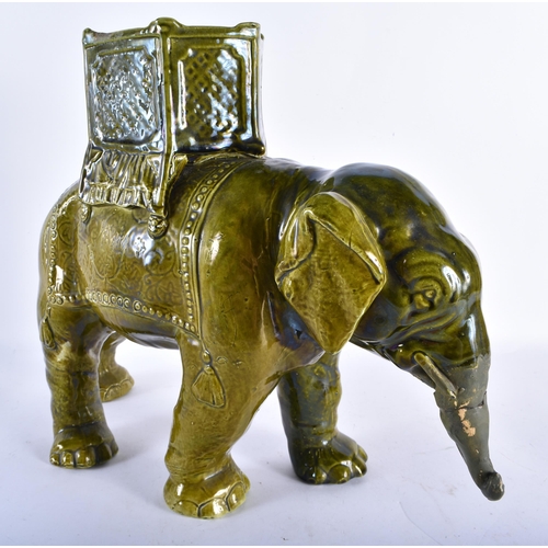 885 - A LARGE 19TH CENTURY CONTINENTAL MAJOLICA POTTERY GREEN GLAZED ELEPHANT VASE. 34 cm x 28 cm.