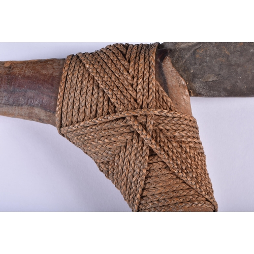 898 - A LOVELY TRIBAL CARVED WOOD ROPE BOUND AXE. 65 cm long.