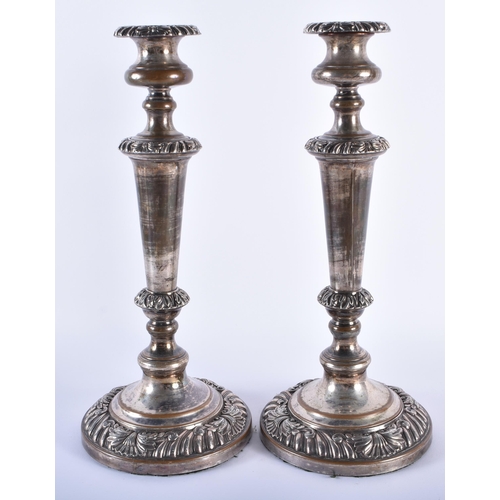 907 - A PAIR OF 18TH/19TH CENTURY OLD SHEFFIELD PLATED CANDLESTICKS decorated in relief with foliage. 34 c... 