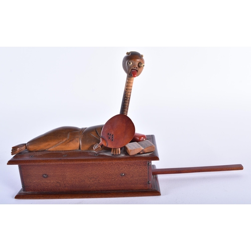 908 - A LOVELY EARLY 20TH CENTURY JAPANESE MEIJI PERIOD KOBE TOY modelled as a recumbent figure holding a ... 