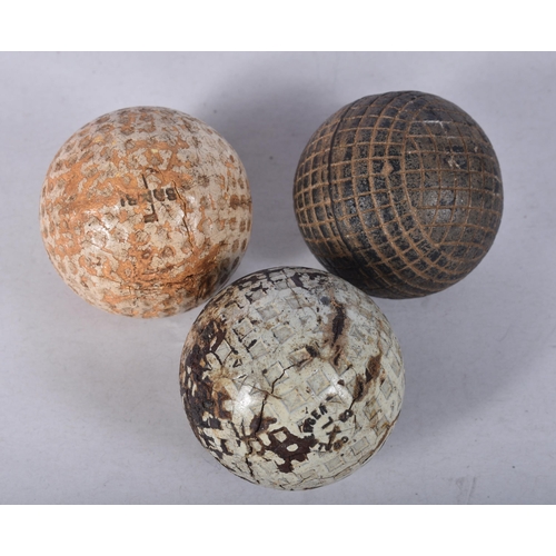 911 - THREE VINTAGE GOLF BALLS. (3)