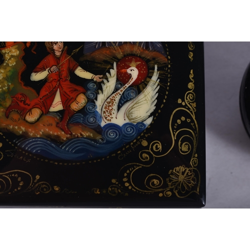 919 - TWO RUSSIAN BLACK LACQUER BOXES. Largest 8 cm square. (2)