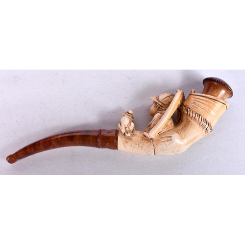 969 - AN ANTIQUE MEERSCHAUM AND AMBER JOCKEY AND DOG PIPE. 15 cm long.