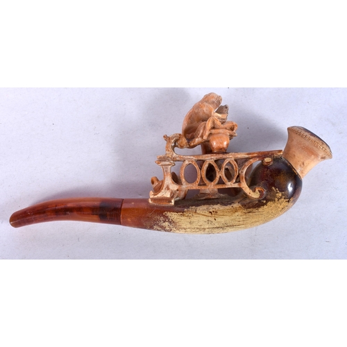 973 - AN ANTIQUE MEERSCHAUM PLAY DOG AMBER PIPE. 12 cm long.