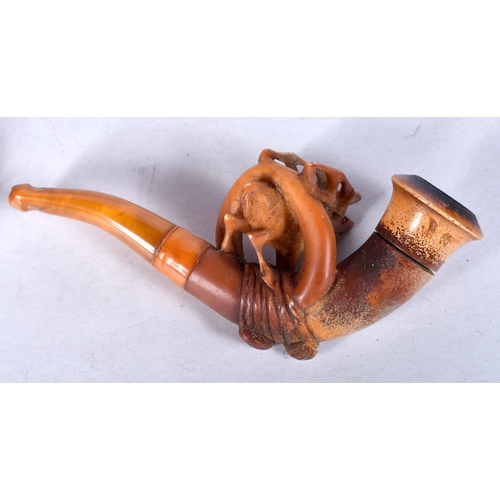 974 - AN ANTIQUE MEERSCHAUM TRAPPED STAG AMBER PIPE. 8 cm long.