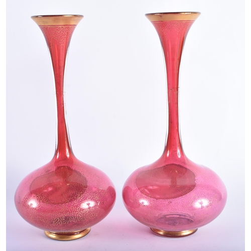 26 - A PAIR OF 19TH CENTURY BOHEMIAN CRANBERRY GLASS VASES painted with portraits of females. 25 cm high.