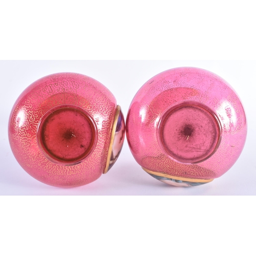 26 - A PAIR OF 19TH CENTURY BOHEMIAN CRANBERRY GLASS VASES painted with portraits of females. 25 cm high.
