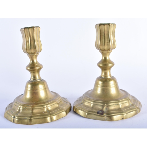 41 - A SMALL PAIR OF ANTIQUE BRASS CANDLESTICKS. 15 cm x 10 cm.