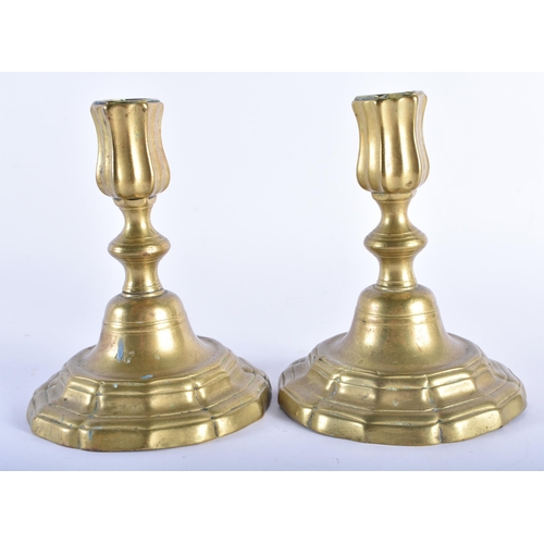 41 - A SMALL PAIR OF ANTIQUE BRASS CANDLESTICKS. 15 cm x 10 cm.