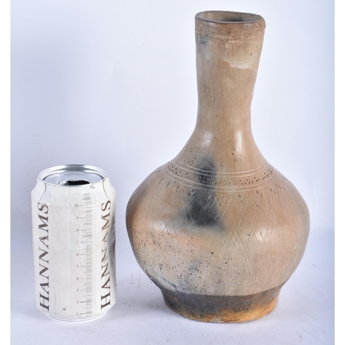 500 - AN EARLY ANTIQUITY POTTERY VASE incised with motifs. 25 cm high.