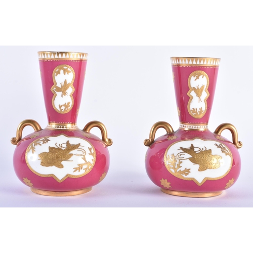 545 - A PAIR OF COALPORT RUBY GROUND PORCELAIN VASES. 12 cm high.