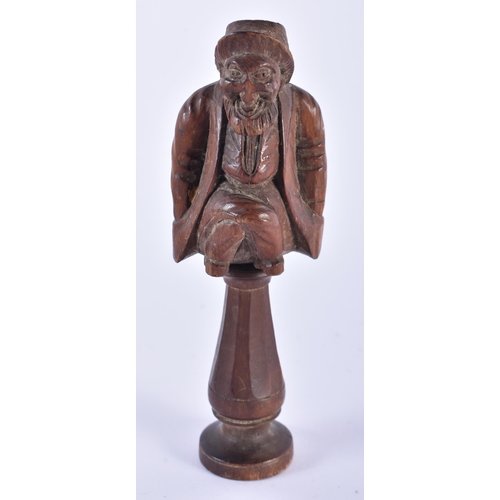 58 - AN ANTIQUE TREEN CARVED WOOD FIGURAL NUT CRACKER. 15.5 cm high.