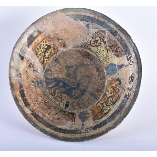 589 - A 12TH/13TH CENTURY IRANIAN NISHAPUR ISLAMIC BOWL painted with a beast amongst calligraphy. 22 cm wi... 