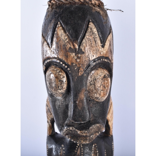 61 - A SET OF THREE CARVED WOOD TRIBAL FIGURES. 50 cm high. (3)