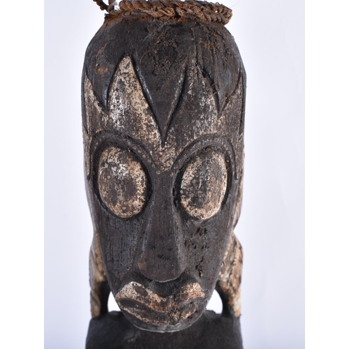 61 - A SET OF THREE CARVED WOOD TRIBAL FIGURES. 50 cm high. (3)