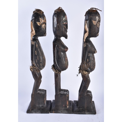 61 - A SET OF THREE CARVED WOOD TRIBAL FIGURES. 50 cm high. (3)