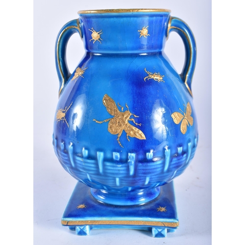 67 - A 19TH CENTURY AESTHETIC MOVEMENT TWIN HANDLED TURQUOISE GLAZED VASE decorated in raised gilt with i... 