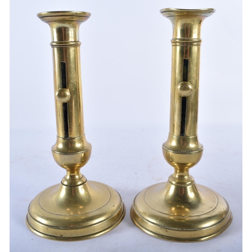 703 - A PAIR OF ANTIQUE ADJUSTABLE BRASS CANDLESTICKS. 21.5 cm high.