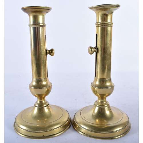 703 - A PAIR OF ANTIQUE ADJUSTABLE BRASS CANDLESTICKS. 21.5 cm high.