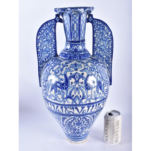 747 - A LARGE 19TH CENTURY CONTINENTAL BLUE AND WHITE TWIN HANDLED FAIENCE ALHAMBRA VASE painted with oppo... 