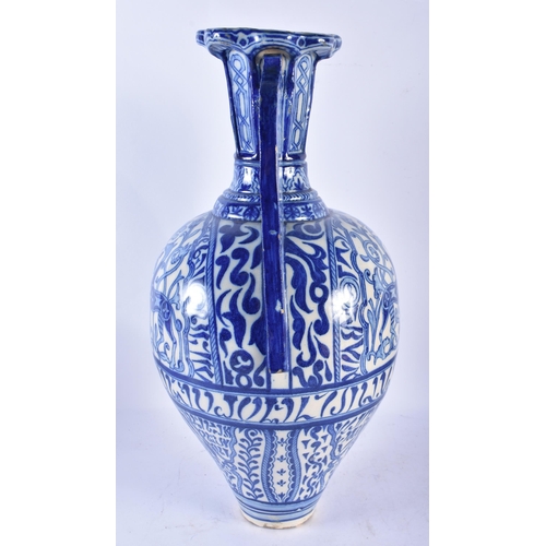 747 - A LARGE 19TH CENTURY CONTINENTAL BLUE AND WHITE TWIN HANDLED FAIENCE ALHAMBRA VASE painted with oppo... 