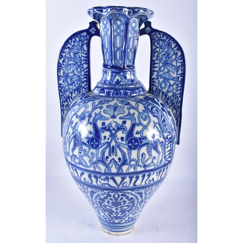 747 - A LARGE 19TH CENTURY CONTINENTAL BLUE AND WHITE TWIN HANDLED FAIENCE ALHAMBRA VASE painted with oppo... 