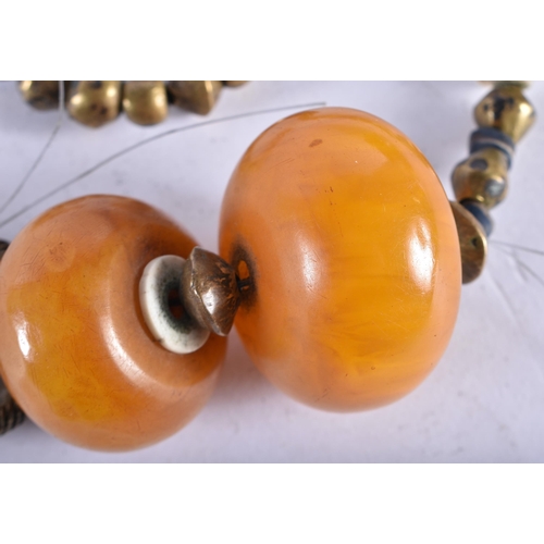 751 - AN UNUSUAL TRIBAL AMBER TYPE GLASS AND GILT BEAD NECKLACE. 130 grams. 50 cm long.