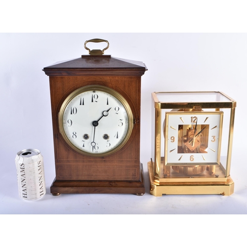 803 - AN ANTIQUE MAHOGANY MANTEL CLOCK together with an Atmos clock. Largest 38 cm high inc handle. (2)