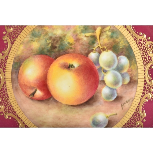 8 - A ROYAL WORCESTER MAROON GROUND PORCELAIN CABINET PLATE by Higgins. 21.5 cm wide.