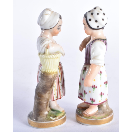 96 - A SMALL PAIR OF 19TH CENTURY CONTINENTAL PORCELAIN FIGURES modelled as children beside baskets. 9.5 ... 