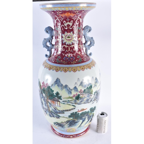 2241 - A VERY LARGE CHINESE RUBY GROUND FAMILLE ROSE TWIN HANDLED PORCELAIN VASE 20th Century. 71 cm high.