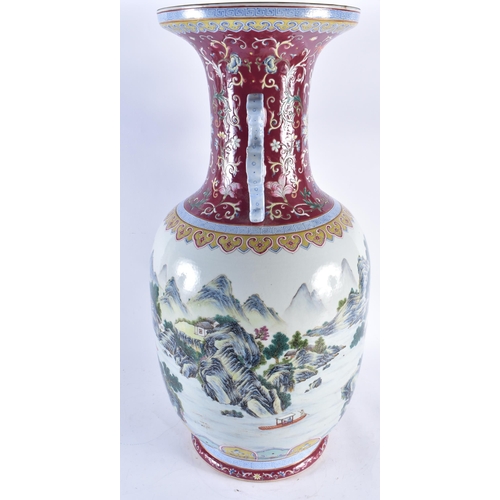 2241 - A VERY LARGE CHINESE RUBY GROUND FAMILLE ROSE TWIN HANDLED PORCELAIN VASE 20th Century. 71 cm high.