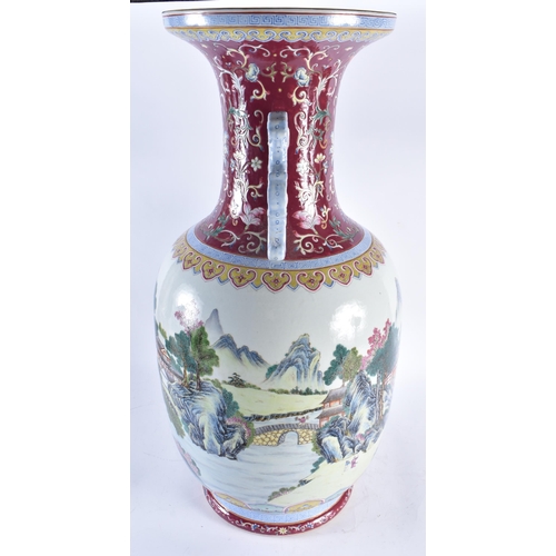 2241 - A VERY LARGE CHINESE RUBY GROUND FAMILLE ROSE TWIN HANDLED PORCELAIN VASE 20th Century. 71 cm high.