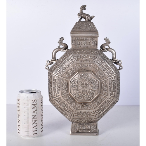 3041 - A Chinese white metal  embossed Moon Flask decorated with twin beast handles and a floral pattern 34... 