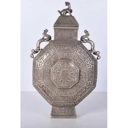 3041 - A Chinese white metal  embossed Moon Flask decorated with twin beast handles and a floral pattern 34... 