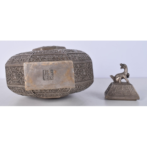 3041 - A Chinese white metal  embossed Moon Flask decorated with twin beast handles and a floral pattern 34... 