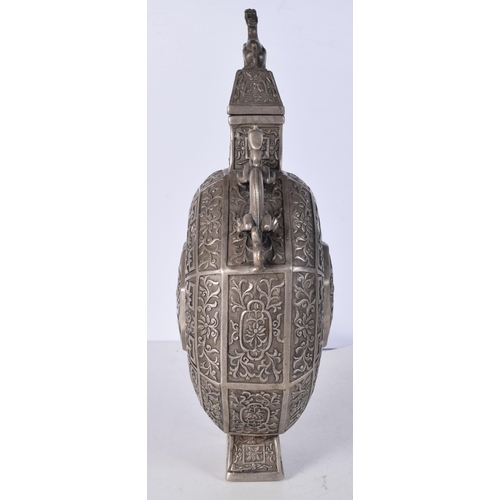 3041 - A Chinese white metal  embossed Moon Flask decorated with twin beast handles and a floral pattern 34... 