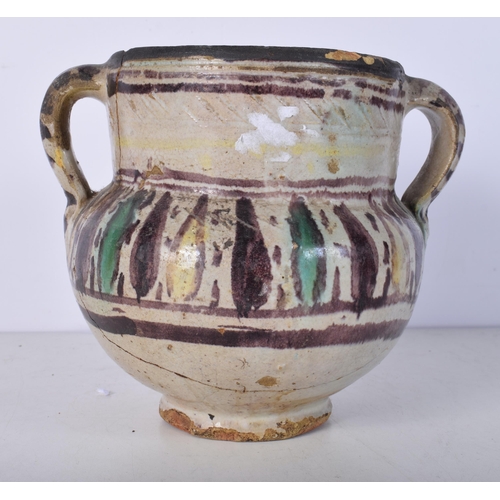 3058 - An early glazed pottery twin handled vase 16.5 x 20cm.