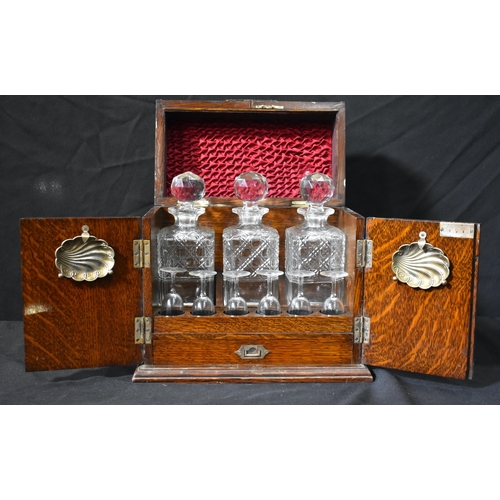 3434 - An Antique oak cased Tantalus  set with three cut glass Decanters and 6 associated glasses 31 x 31 x... 